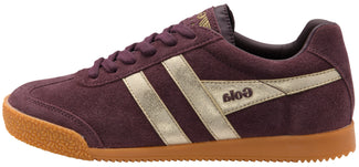 A low-top Gola sneaker in dark purple suede with metallic silver side stripes and a brown gum sole, shown from a side profile on a white background.