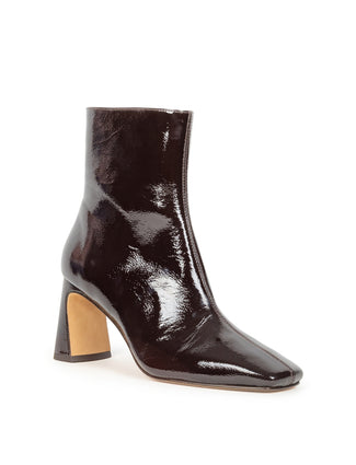 A glossy burgundy patent leather ankle boot with a block heel and pointed toe, shown from a side profile on a white background.