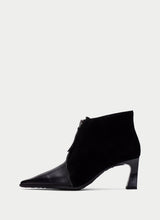Load image into Gallery viewer, A single black ankle boot with a pointed toe, a mid-height block heel, and a side zipper, shown from a side profile on a light gray background.

