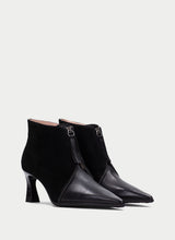 Load image into Gallery viewer, A pair of black pointed-toe ankle boots with a mix of matte suede and smooth leather panels, featuring a mid-height block heel and a side zipper with a metal ring pull, shown against a light gray background.
