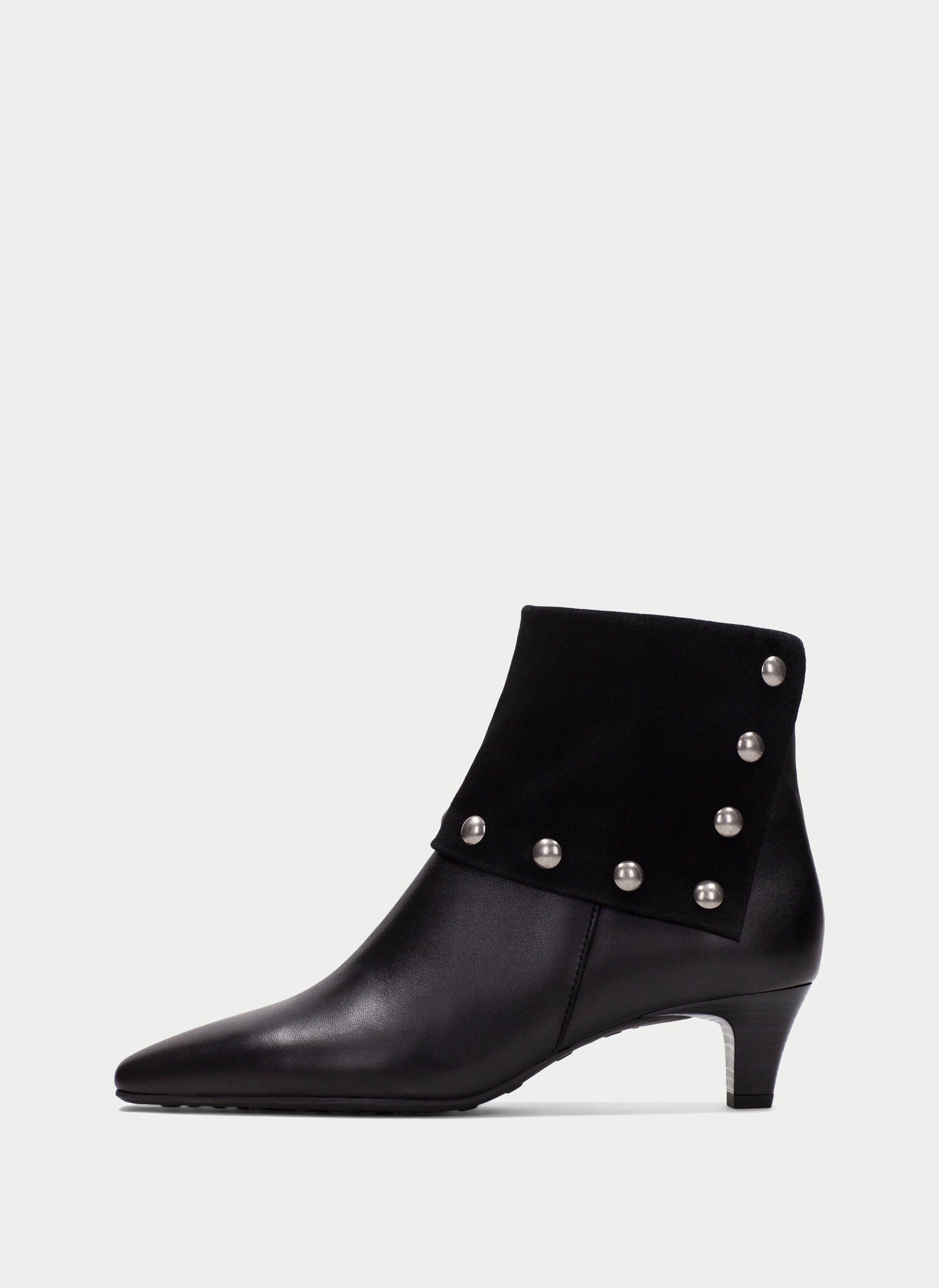 A black leather ankle boot with a pointed toe, a low kitten heel, and silver-tone metal studs along the side, shown against a light gray background.