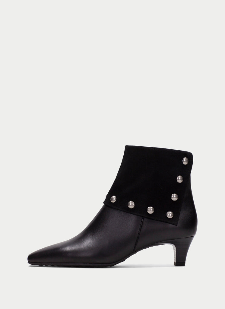 A black leather ankle boot with a pointed toe, a low kitten heel, and silver-tone metal studs along the side, shown against a light gray background.