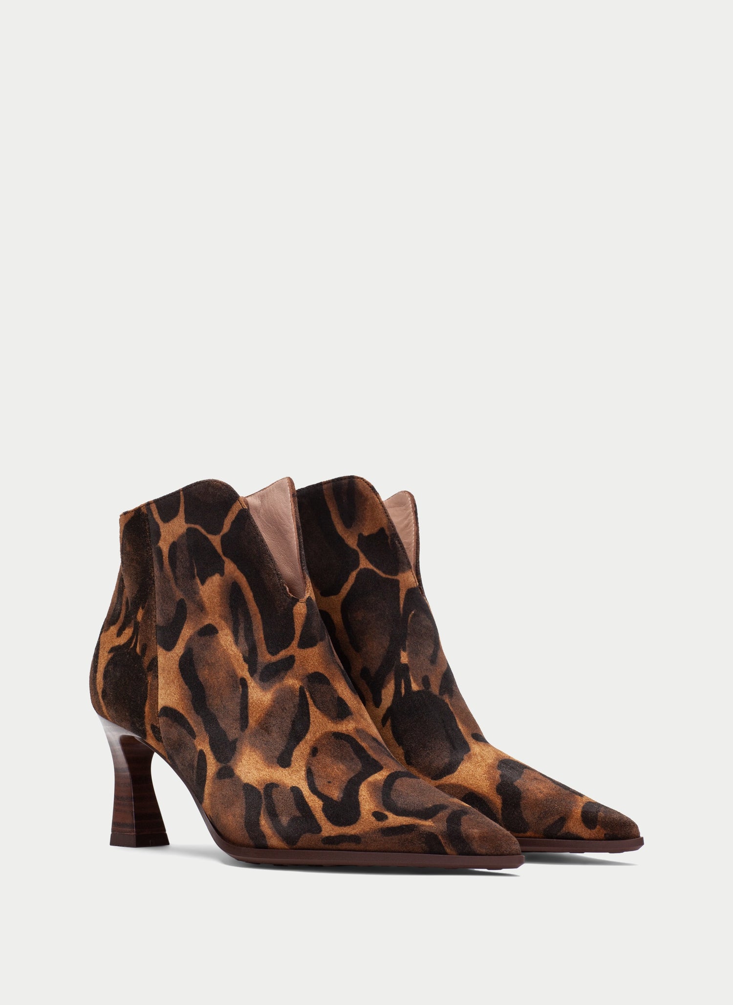 A pair of pointed-toe ankle boots with a brown and black leopard print pattern, set against a plain light gray background.