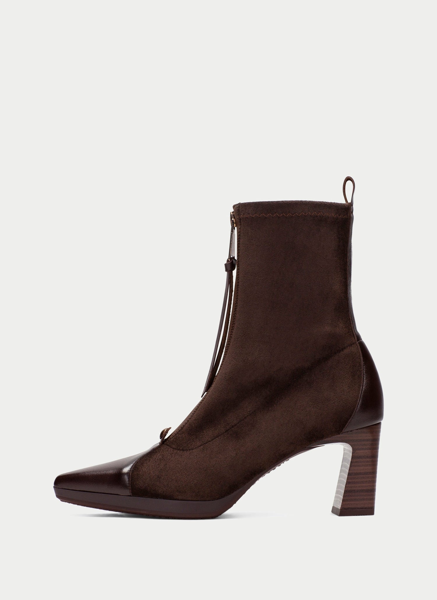A dark brown ankle boot with a pointed toe, a chunky block heel, and a side zipper with a tassel detail, shown against a light gray background.