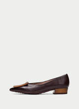 Load image into Gallery viewer, A dark brown leather pointed-toe flat shoe with a low block heel and a tan leather tassel detail on the toe, shown in profile against a light gray background.
