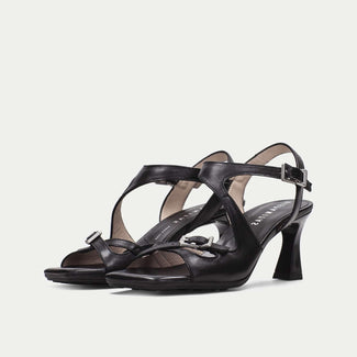 Black high-heeled sandals on a white background