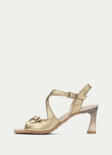 Load image into Gallery viewer, Gold high-heeled sandal on a light beige background
