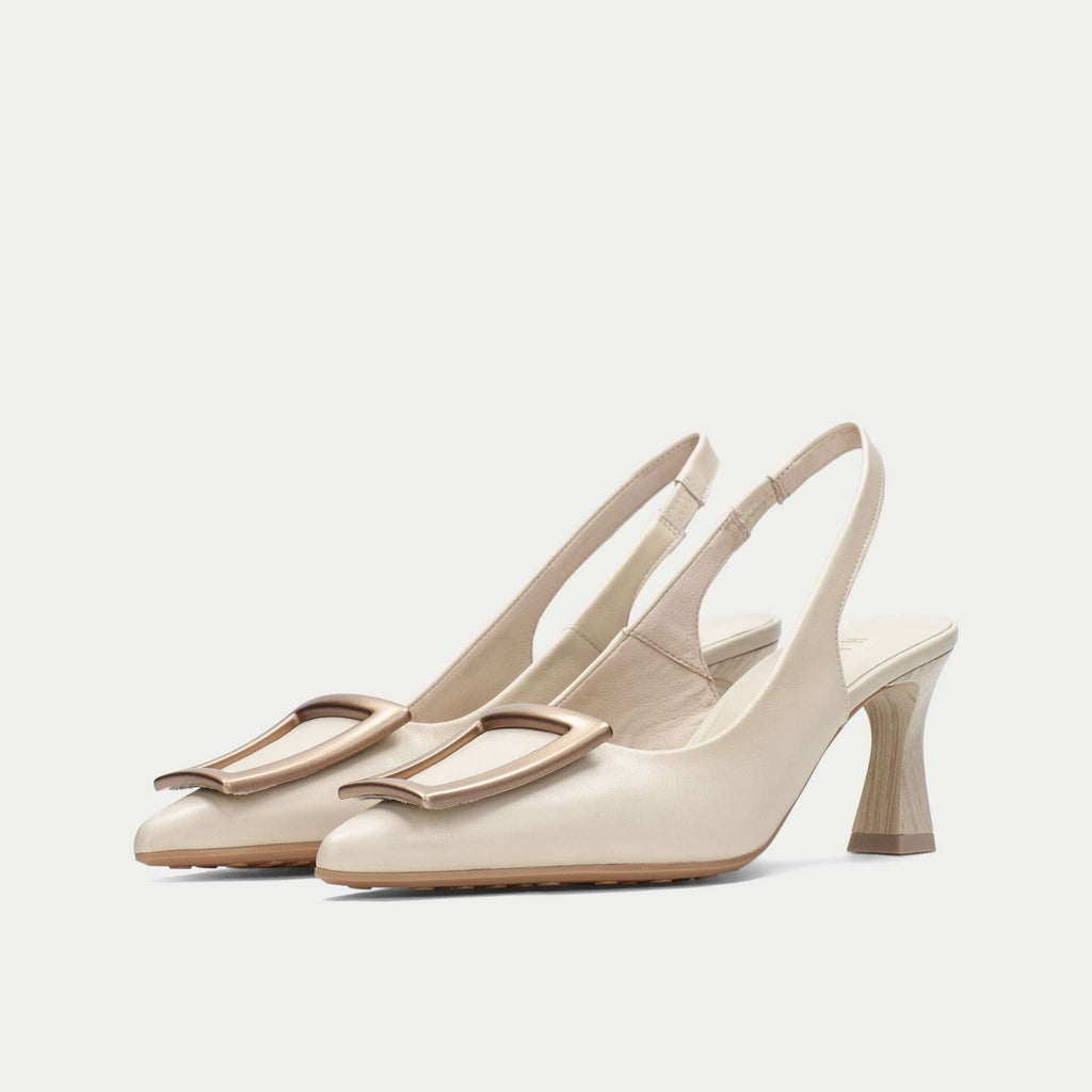 Pair of beige slingback heels on a light gray background