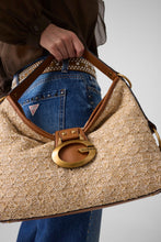 Load image into Gallery viewer, Person holding a beige handbag with a gold clasp against a neutral background
