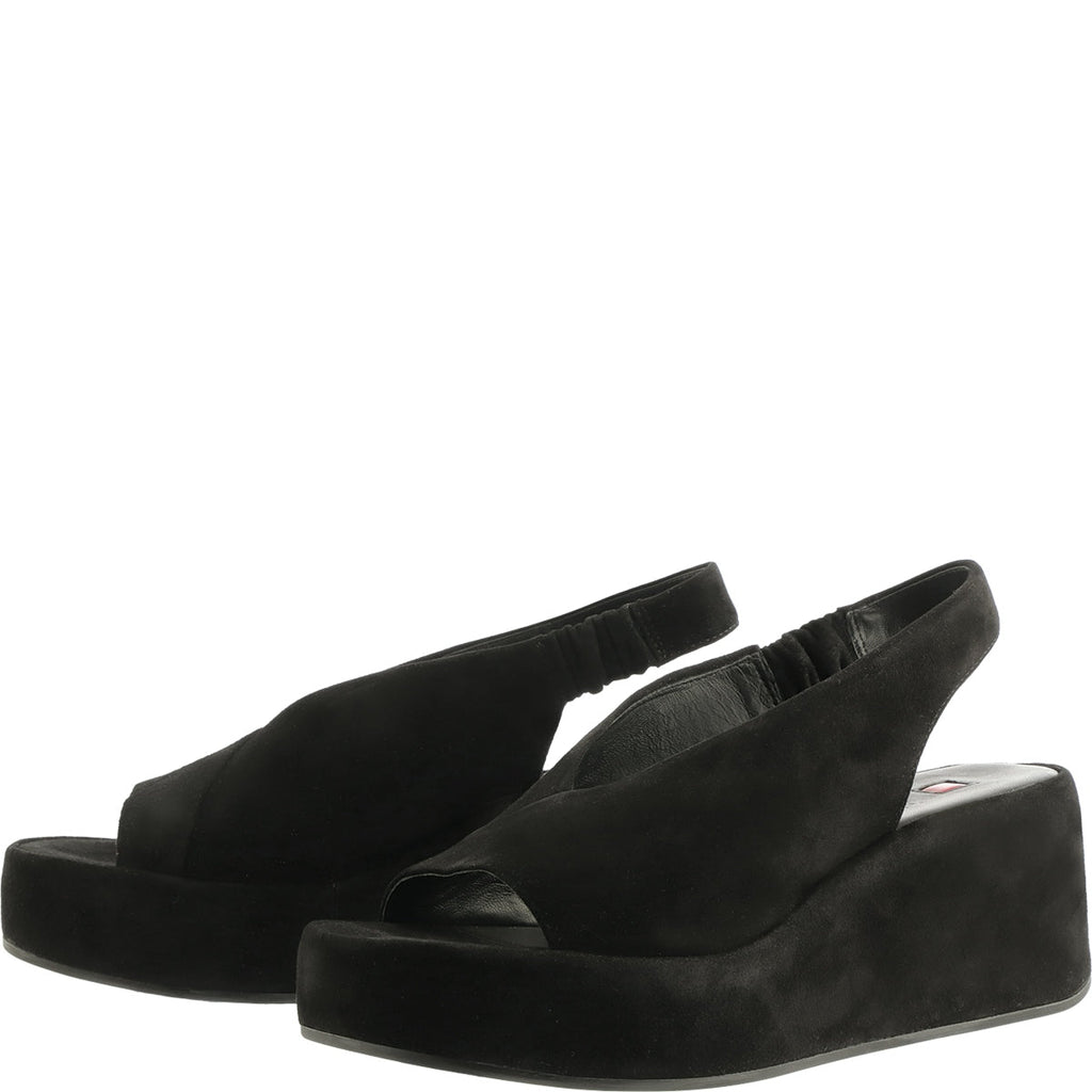 Black suede wedge sandals on a white background