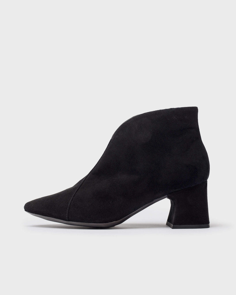 A single black suede ankle boot with a chunky block heel and pointed toe, shown in profile against a light gray background.