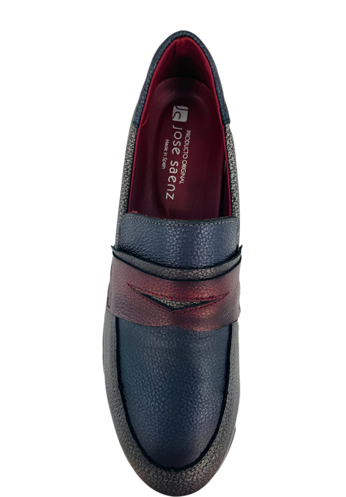 Blue loafer shoe with red accents on a white background