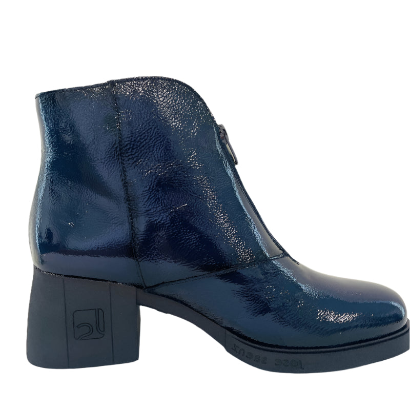 Blue patent leather ankle boot on a white background