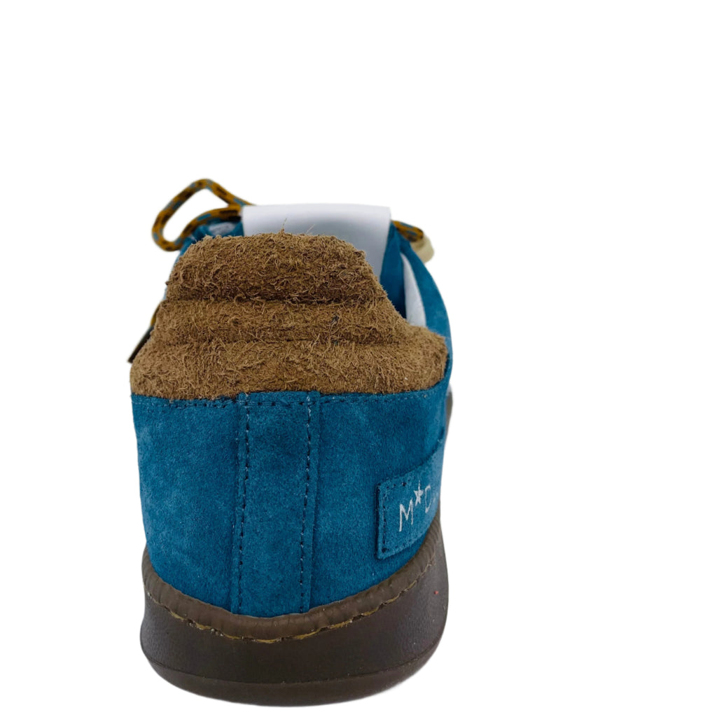 Blue and brown shoe on a white surface with a light gray background