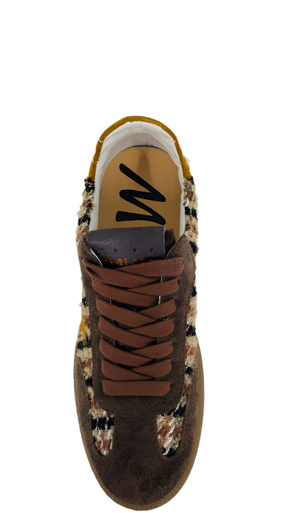 Brown sneaker with patterned sole on a white background