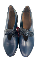 Load image into Gallery viewer, Pair of blue shoes with decorative bows on a white surface.
