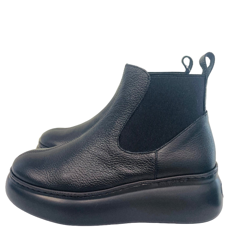 Black leather Chelsea boots on a white background