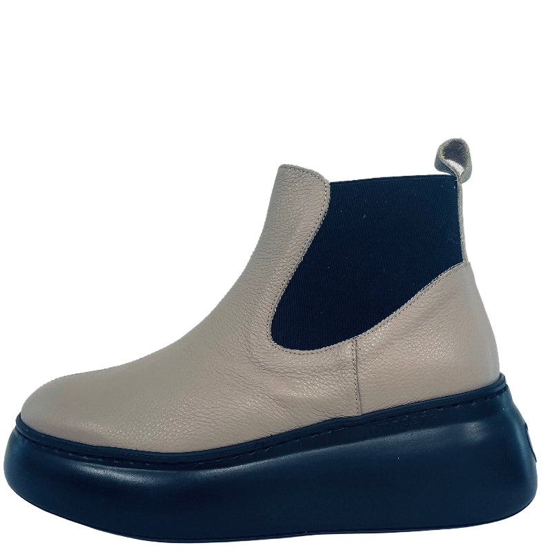 Beige and black ankle boot on a white background