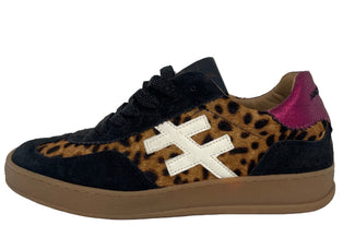 Sneaker with leopard print and black design on a white wall