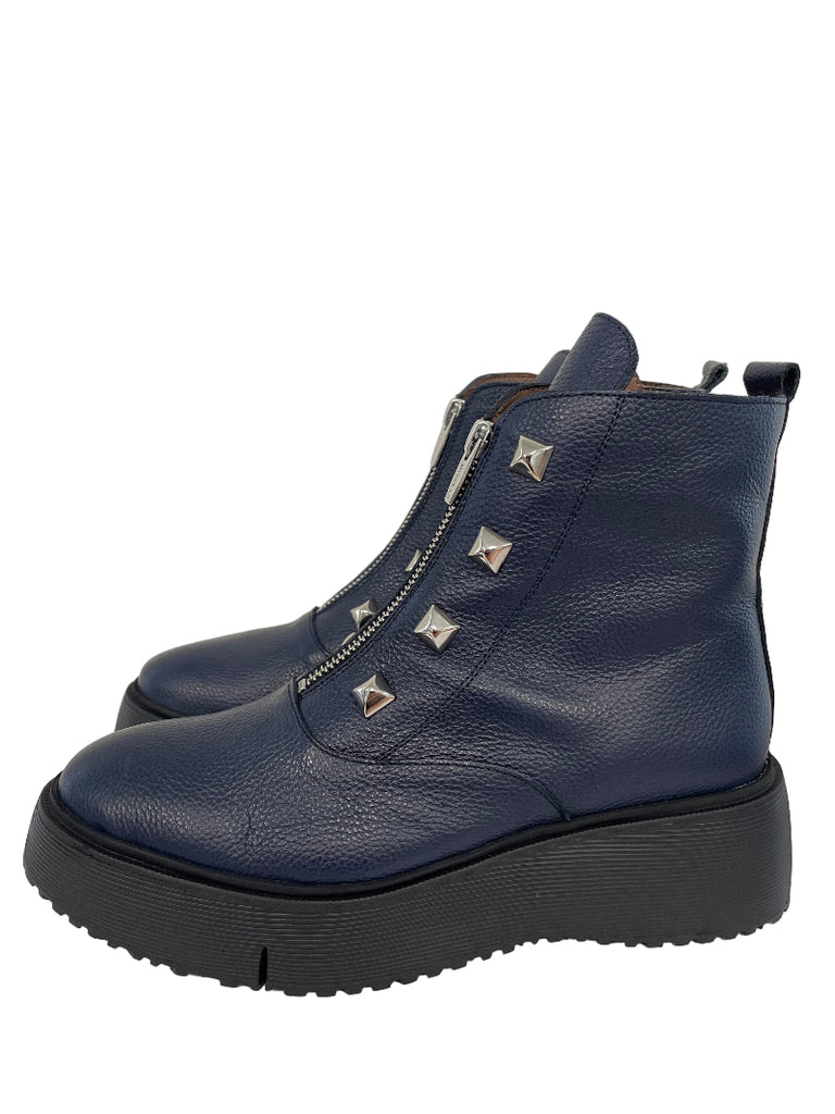 Navy blue boot with silver studs on a light gray background