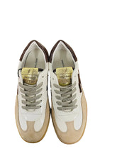Load image into Gallery viewer, Pair of white sneakers with brown accents on a wooden surface.
