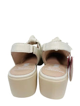 Load image into Gallery viewer, Pair of beige sandals with a visible brand tag on a white background
