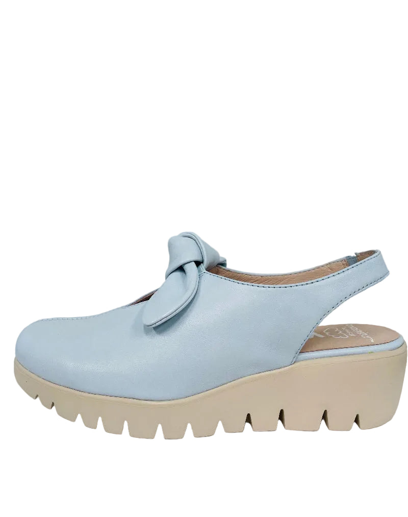 Light blue shoe with a bow on a white surface