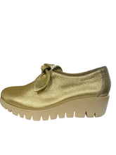 Load image into Gallery viewer, Gold shoe with a thick sole on a white surface
