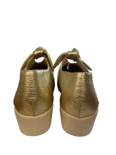 Load image into Gallery viewer, Pair of gold high-heeled shoes on a white surface with a blurred background
