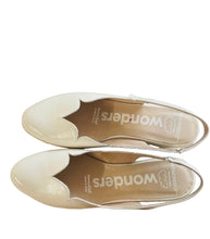 Load image into Gallery viewer, Pair of white shoes with 'Wonders' branding on a wooden surface.
