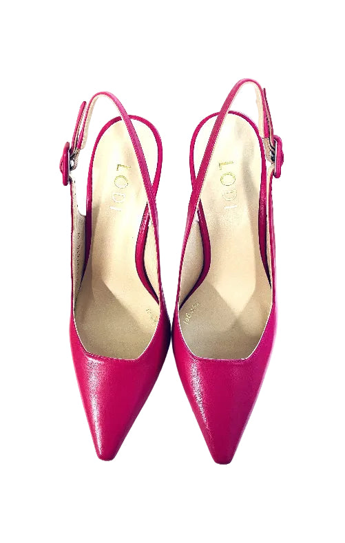 Pair of bright pink high-heeled shoes on a white surface with a wooden background