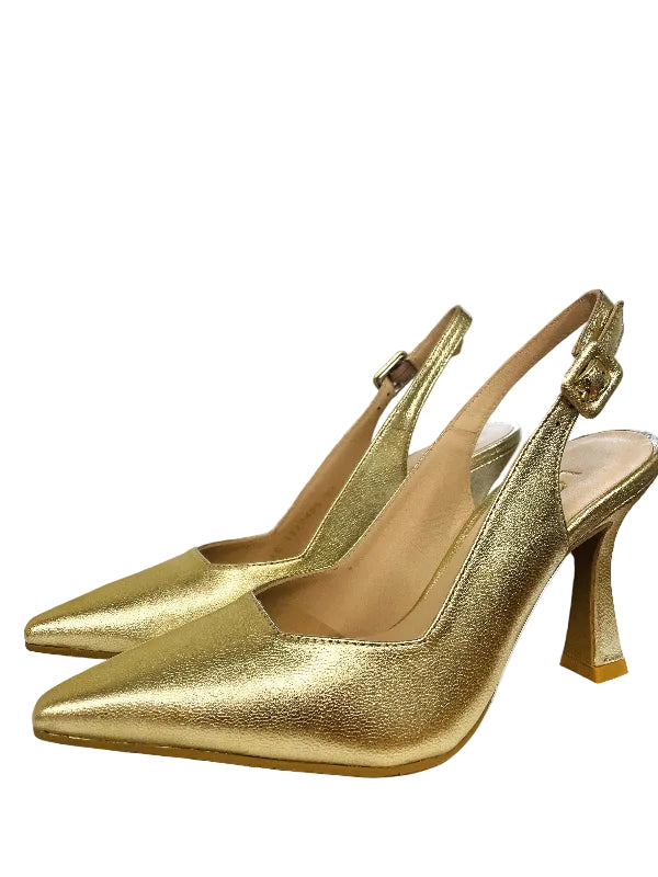Gold high-heeled shoes on a surface with a blurred background