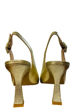 Load image into Gallery viewer, Pair of gold high-heeled shoes on a white surface with a window in the background.
