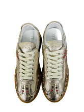 Load image into Gallery viewer, Pair of gold sneakers with colorful studs on a white surface
