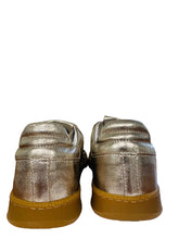 Load image into Gallery viewer, Pair of metallic gold shoes with brown soles on a white surface.

