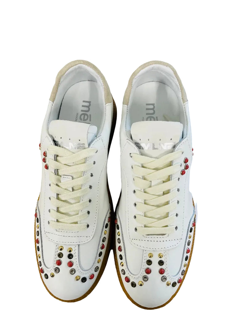 White sneakers with colorful embellishments on a white background