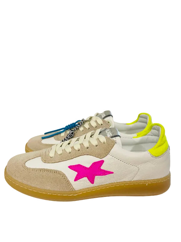 Pair of sneakers with a pink star on a white surface, with a window and building view in the background.