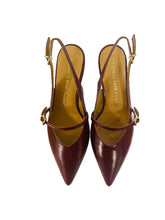 Load image into Gallery viewer, Pair of maroon high-heeled shoes with thin straps on a white card, placed on a wooden surface.
