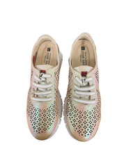 Load image into Gallery viewer, Pair of light pink sneakers with black perforations on a wooden surface.
