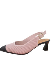 Load image into Gallery viewer, Pink and black high-heeled shoe on a wooden surface with a white wall background
