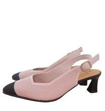 Load image into Gallery viewer, Pink and black high-heeled shoes on a wooden surface with a white wall background.

