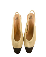 Load image into Gallery viewer, Pair of beige and black shoes on a wooden surface with a tiled wall background

