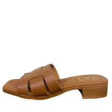 Load image into Gallery viewer, Brown sandal on a wooden surface with a white wall background
