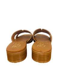 Load image into Gallery viewer, Pair of brown sandals on a wooden surface with a white wall in the background
