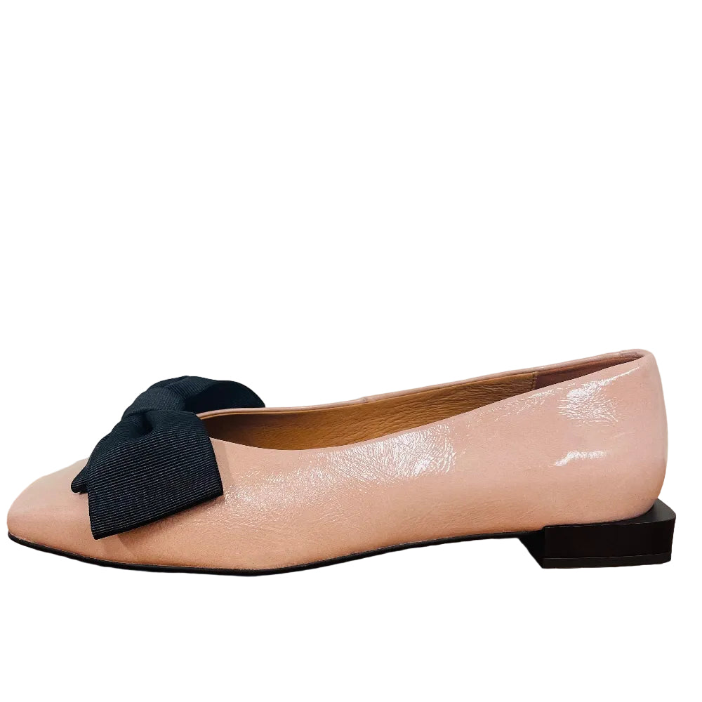 pink flat shoe with a black bow 