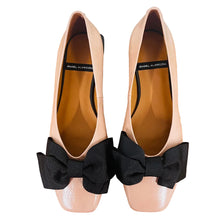 Load image into Gallery viewer, Pair of pink flats with black bows on a wooden surface
