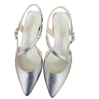 Silver shoe with a brown heel on a wooden surface