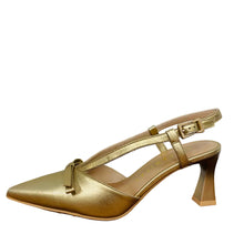 Load image into Gallery viewer, Gold high-heeled shoe on a wooden surface with a white wall background
