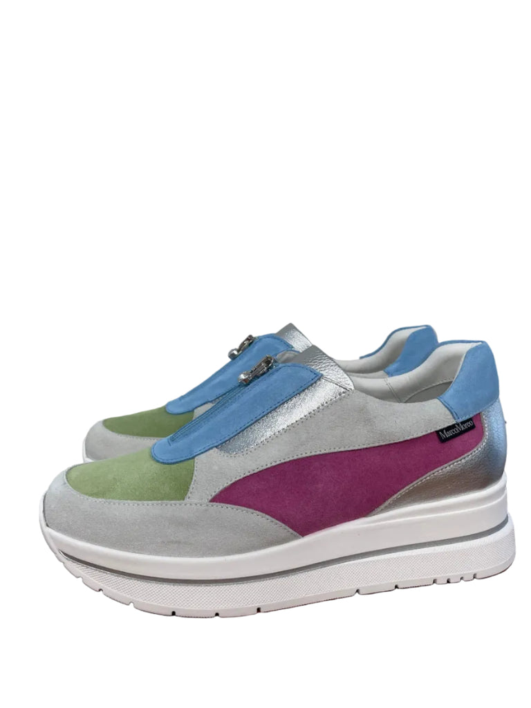 Colorful sneaker with a thick white sole on a wooden floor.