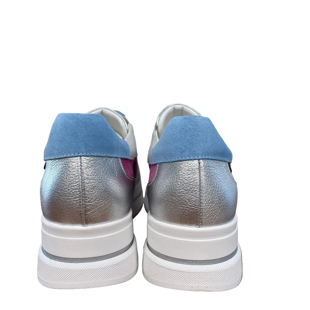 Pair of silver and blue sneakers on a wooden floor.